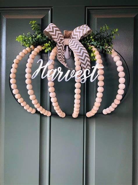 Dollar Tree Pumpkin Wire Wreath Using Wood Beads The Happy Farmhouse