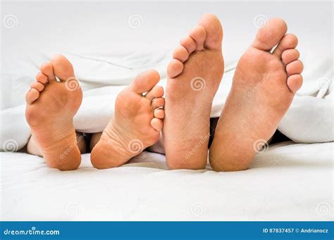 Feet Of A Couple In Bed Under The Blanket Stock Image Image Of Home