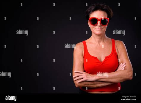 Mature Beautiful Woman With Short Hair Against Black Background Stock Photo Alamy