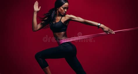 Strong Woman Using A Resistance Band In Her Exercise Routine Stock