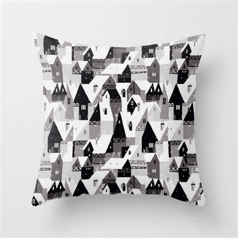 A Black And White Pillow With Houses On It