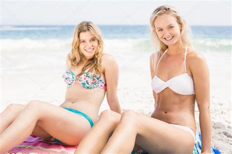 Pretty Women In Bikini Sitting On The Beach Stock Photo