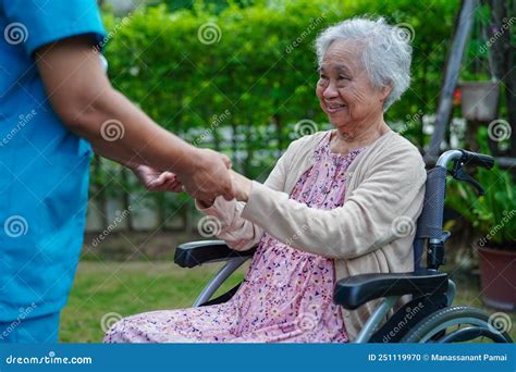 Caregiver Help And Care Asian Senior Or Elderly Old Lady Woman Patient Sitting On Wheelchair In