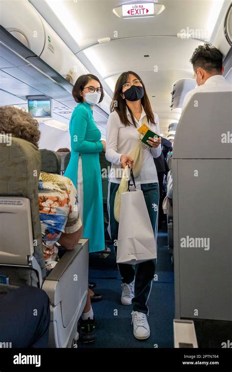 Vietnam Airlines Cabin Crew Taking Care Of Passengers Wearing Ao Dai