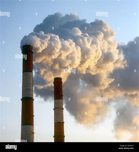 Air pollution by smoke coming out of two factory chimneys Stock Photo ...