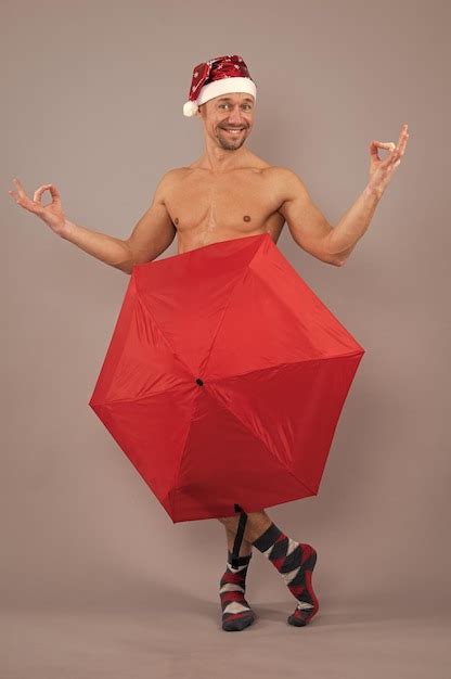 Premium Photo Crazy Nude Santa Covered Underwear With Umbrella Naked