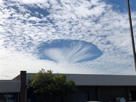 Hole punch cloud in Oakland today : r/pics