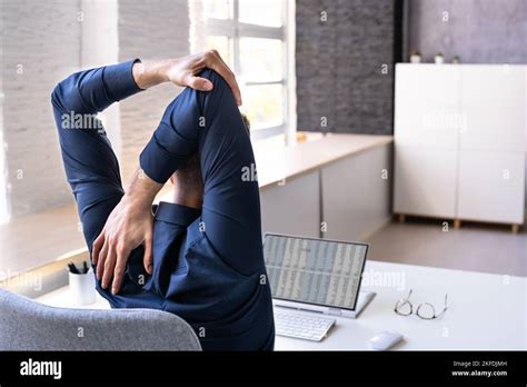 Employee Stretching At Office Desk At Work Stock Photo Alamy