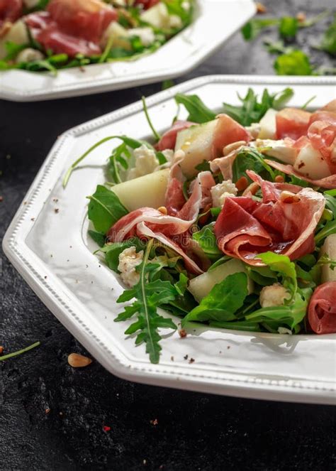 Parma Ham And Melon Salad With Mozzarella Rocket And Pine Nuts Stock