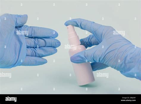 Girl Holding An Antiseptic Against Bacteria In Blue Rubber Gloves Stock