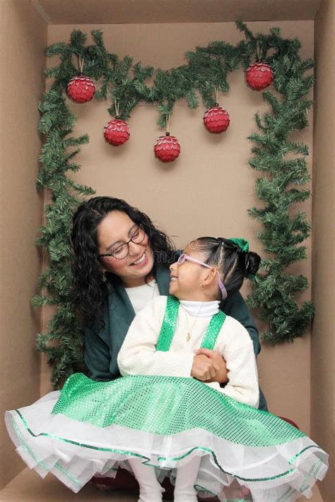 Mom With Her Year Old Brunette Daughter With Eyeglasses Inside A Decorated Gift Box To