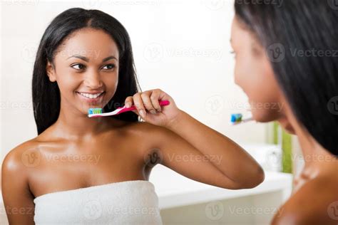 Taking Care Of Her Teeth Beautiful Young African Woman Brushing Her