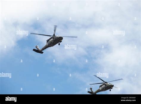 Two Army Helicopters Flying Over Crowd During Independence Day Military