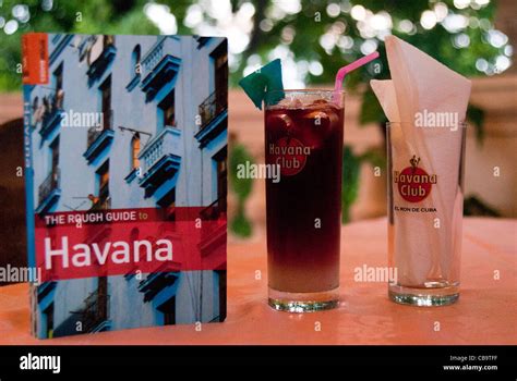 The Rough Guide To Havana Placed On A Table With Rum Drink And Napkins In Havana Club Glasses