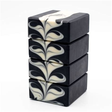 Three Black And White Soaps Stacked On Top Of Each Other One With