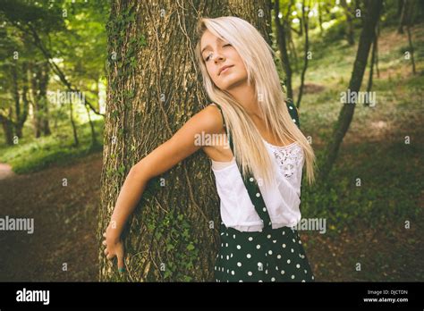Peaceful Gorgeous Blonde Holding Trunk Behind Her Back Stock Photo Alamy