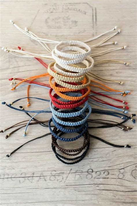 A Stack Of Bracelets Sitting On Top Of A Wooden Table