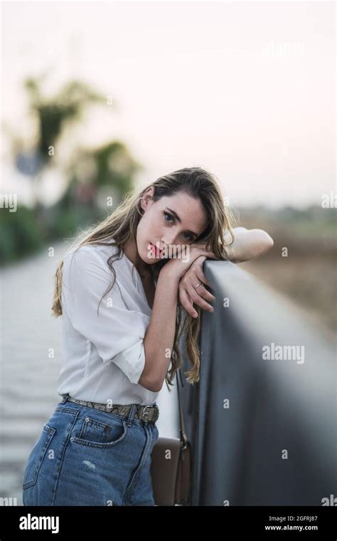 Portrait Of A Spanish Woman With Long Highlighted Hair Leaning On A