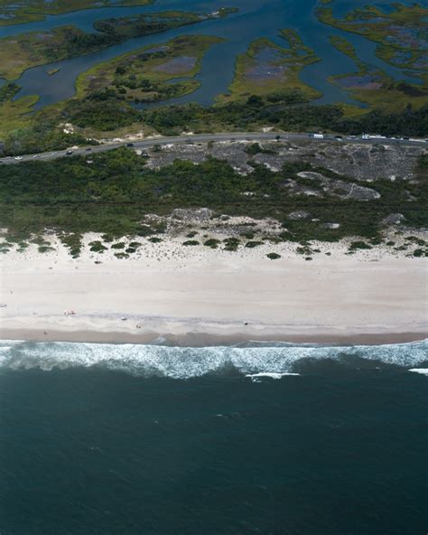 Aerial View Of Green And Brown Land Near Body Of Water During Daytime Photo Free Assateague