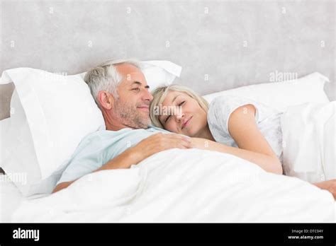 Loving Mature Man And Woman Lying In Bed Stock Photo Alamy
