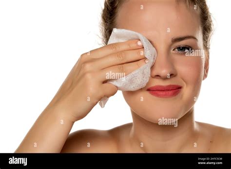 Portrait Of A Blonde Beautiful Smiling Woman Cleans Makeup From Her Face With A Wet Wipe On A