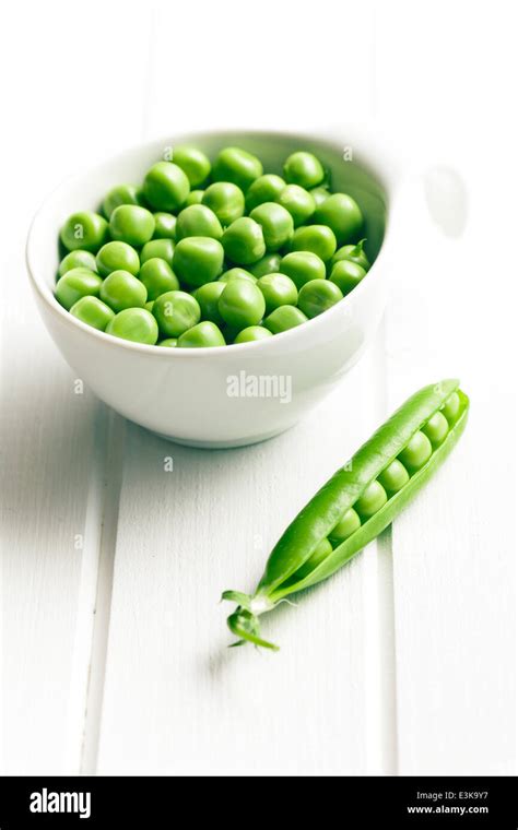 Green Peas In Bowl On White Wooden Table Stock Photo Alamy