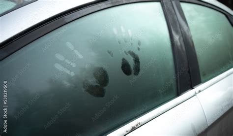 A Couple Of Handprints On The Car Window Prints On The Fogged Glass In