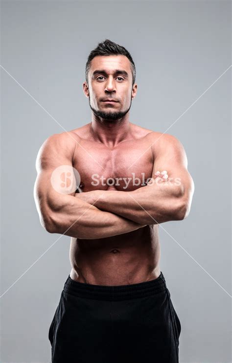 Muscular Man With Arms Folded Standing Over Gray Background Royalty