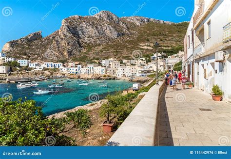 Visitors Enjoy The Coastline During Their Trip Of Small Village On