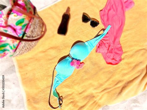 Women Beachwear Bikini Sunglasses Dress And Bag On Yellow Blanket At Beach Sand Stock Photo