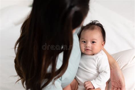 Adorable Newborn Baby Smile And Relax In Mother Arm Safety And