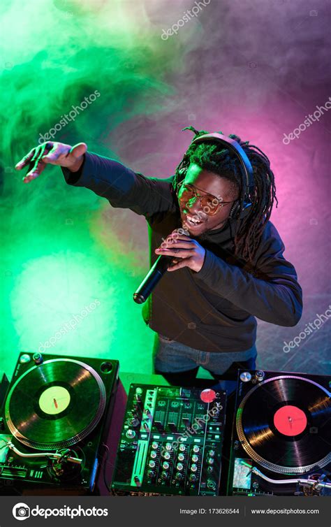 DJ in headphones with microphone Stock Photo by ©AllaSerebrina 173626544