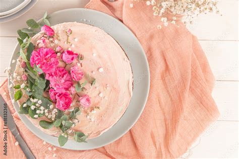 Chocolate Naked Cake With Fresh Roses And Swiss Buttercream On A White Background Stock Photo