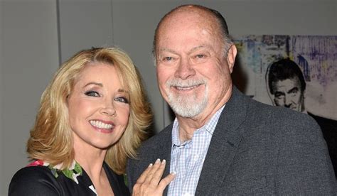 an older man and woman posing for the camera