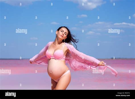 Beautiful Pregnant Woman In Pink Lingerie On Salt Pink Lake Stock Photo Alamy