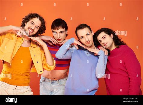 Cheerful Voguish Gay Men With Makeup In Vibrant Attires Posing Actively Together Pride Month