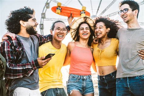 Multiracial Group Of Friends Smiling Together Hanging Outside On A