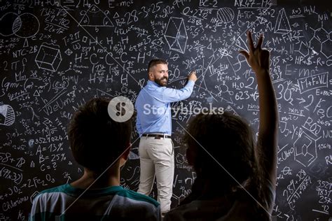 School teacher in front of big blackboard and his students Royalty-Free ...