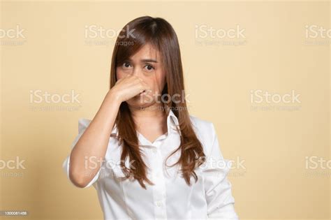 Young Asian Woman Holding Her Nose Because Of A Bad Smell Stock Photo