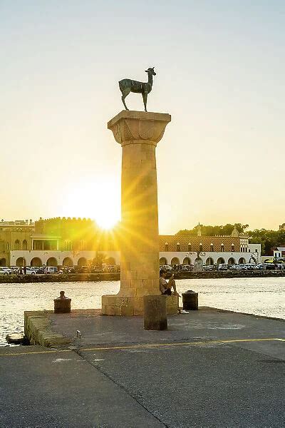 The Statues Of The Myth Colossus Of Rhodes At Sunset