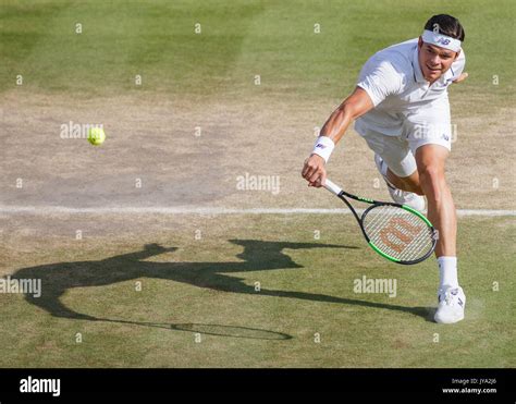 MILOS RAONIC in action at Wimbledon Stock Photo - Alamy