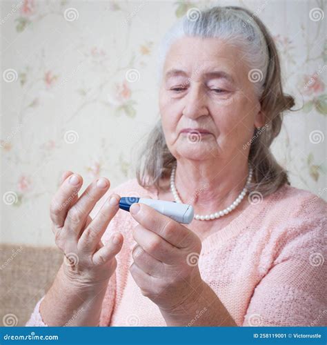 Senior Woman Checking Blood Sugar Level Using Glucometer. Closeup Hand