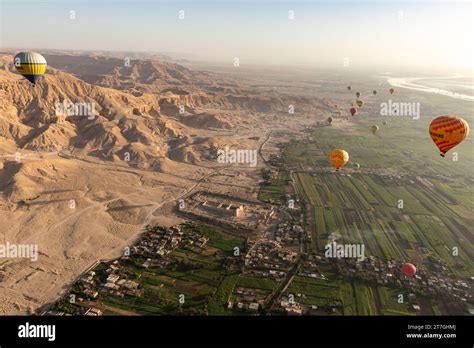 Hot Air Balloons Soaring Over Arid Desert Landscape Of The Valley Of