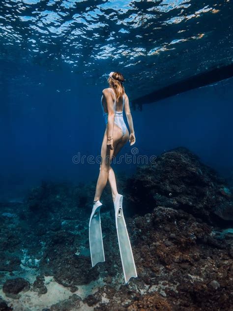 Close Up View Of Ideal Woman Freediver In Red Bikini Underwater In Blue