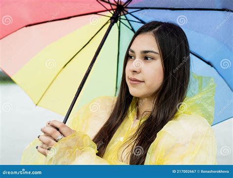 Beautiful Brunette Woman Holding Colorful Umbrella Out In The Rain