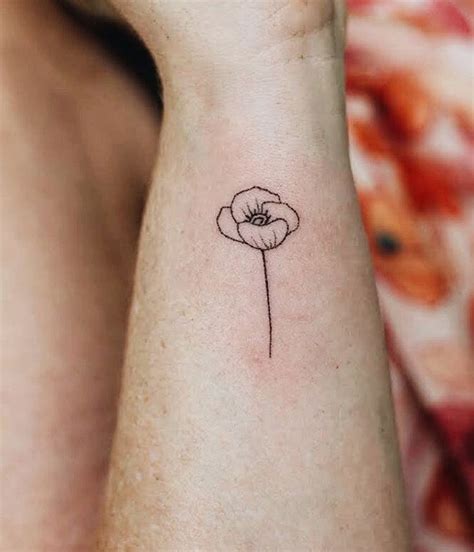 A Single Flower Tattoo On The Wrist