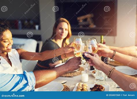 Cheers To Many More Years Of Friendship A Group Of Friends Raising Up Their Glasses For A Toast