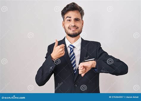 Young Hispanic Man With Tattoos Wearing Business Suit And Tie Doing