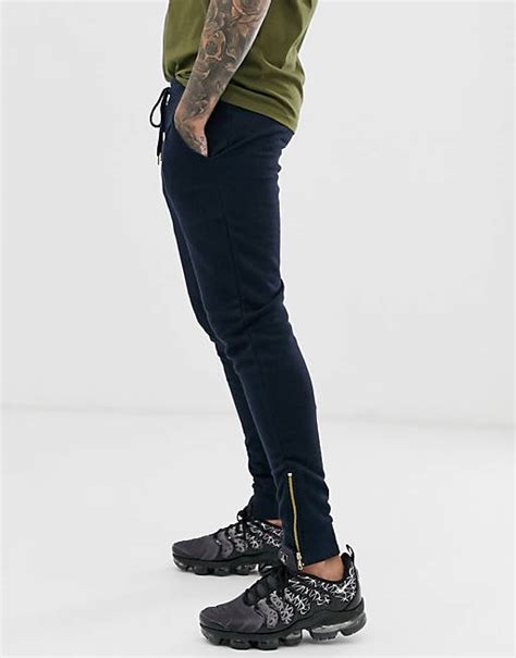 Asos Design Skinny Trackies In Navy With Gold Zip Cuffs Asos