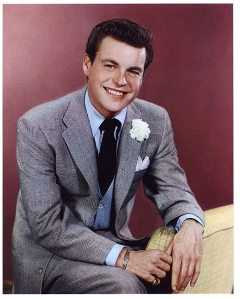 A Man In A Suit And Tie Sitting On A Chair